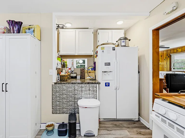 MAIN FLOOR KITCHEN: Storage, Workbench, and Refrigerator (Stove on right, Sink behind camera, Dishwasher to left) 
(UNSHOWN: LAUNDRY AREA, 1/2 BATH, AND GREAT ROOM TO RIGHT)