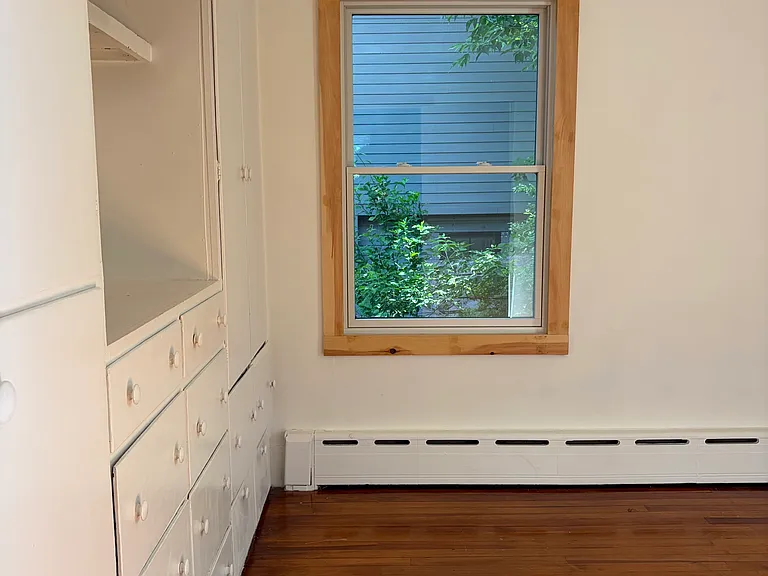 Downstairs bedroom facing the backyard with built in drawers & closets.