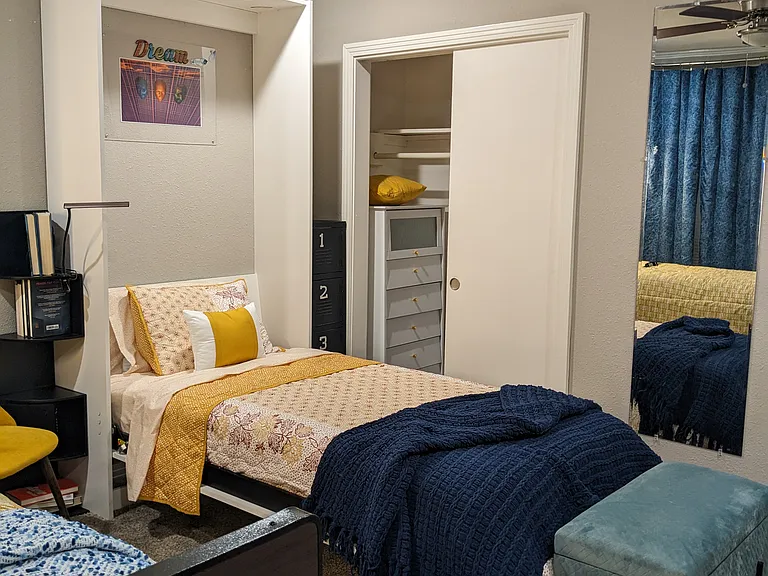 (Older photo- there is a more recent photo. For illustrative purposes- showing chest of drawers inside closet and potential for another bed in this room)