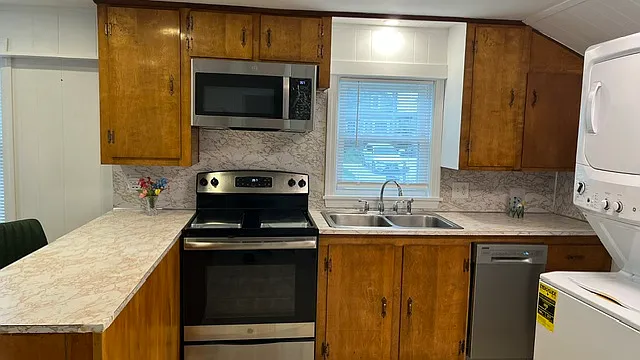 Lovely restored vintage kitchen with modern amenities, New dishwasher, new microwave over the stove, and newer stove.