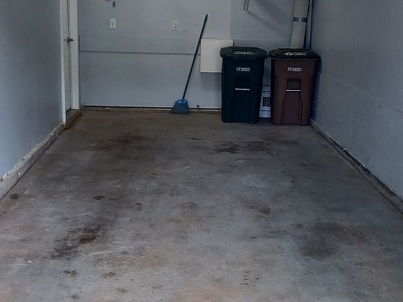 Garage with entrance to house and some storage