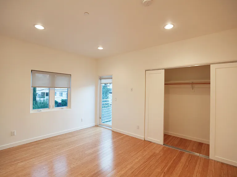 30. Rear Bedroom Balcony and Closet Doors Looking West