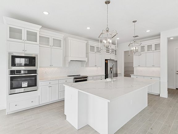 Kitchen with stacked glass-front upper cabinets