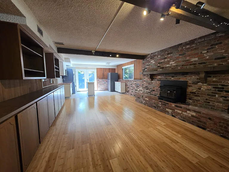 Beautiful brick hearth and wood mantle.
