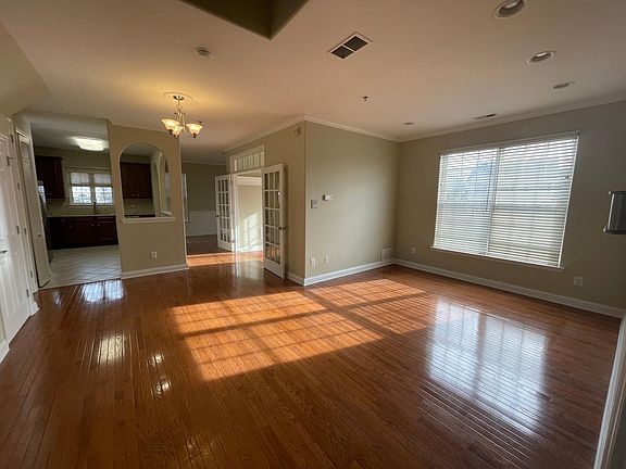 Open Concept Living, Dining & Kitchen. Hardwood floors, lots of windows. French doors into a sunroom.