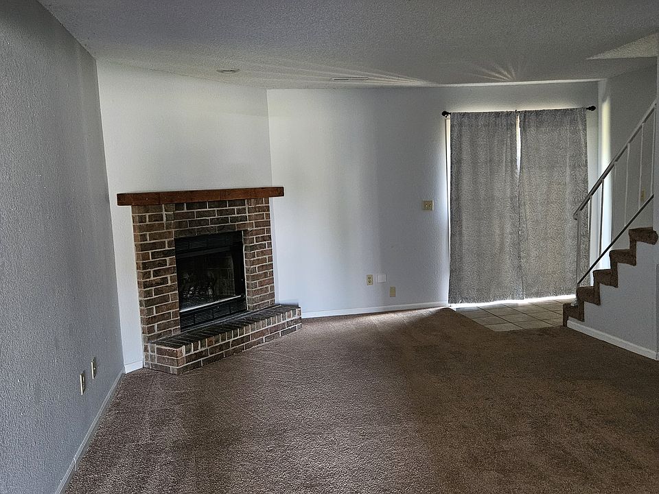 Living room showing fireplace and sliding door for patio