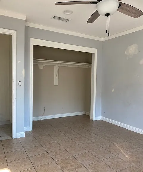 View of the first bedroom & ceiling fan. There are closet doors there now.