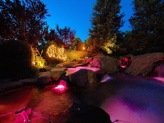 Tiki torches and spa lit up 