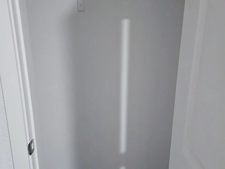 Dedicated closet storage with a full-length hanging rod and upper shelf for organizing clothes, shoes, and linens.
