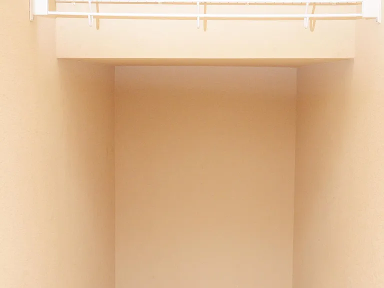 Hanging closet and storage space under the stairwell in this picture