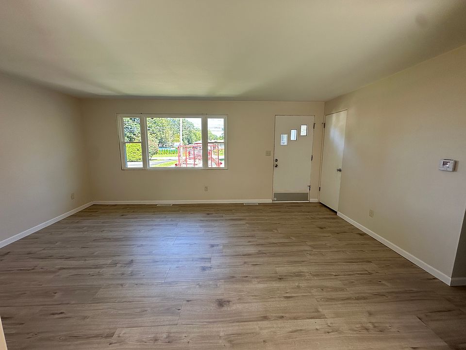 LIVING ROOM, NEW LUXURY VINYL FLOORING, BRAND NEW ELECTRICAL RECEPTACLES, FRESHLY PAINTED, ALL NEW WINDOWS FOR HIGH ENERGY EFFICIENCY
