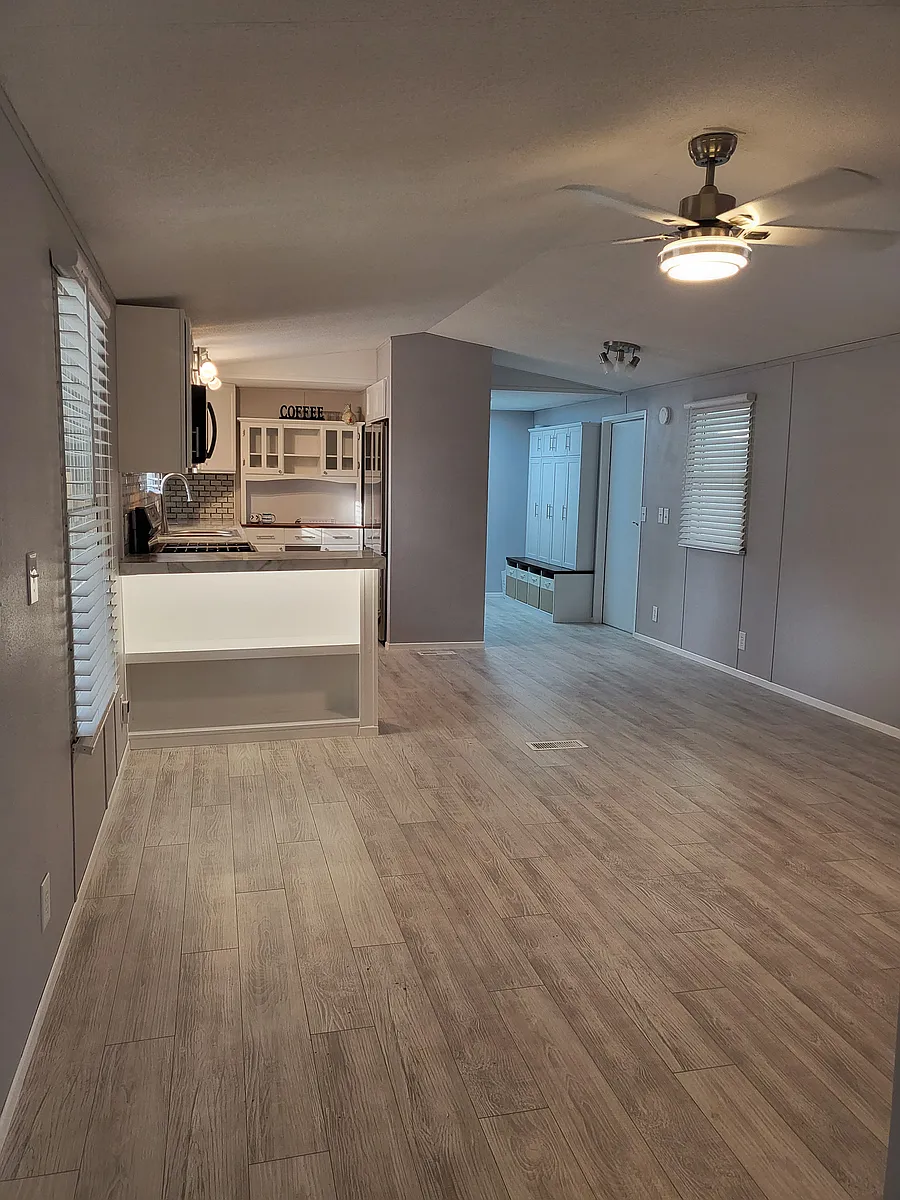Laminate flooring throughout the open floor kitchen living dining area for low maintenance, waterproof, sturdiness... - 286 Aubin Ln