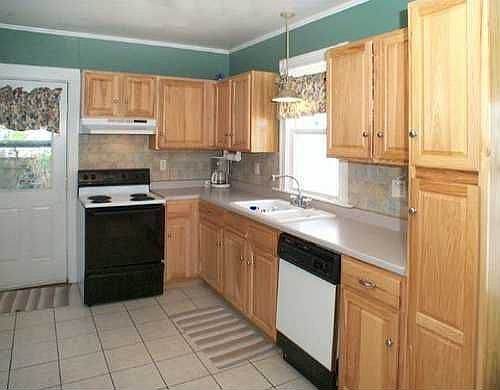 Large recently renovated kitchen leads to back yard for easy entertaining.