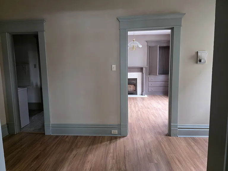 Mid room view into the dining room on right and 1/2 bath on left.