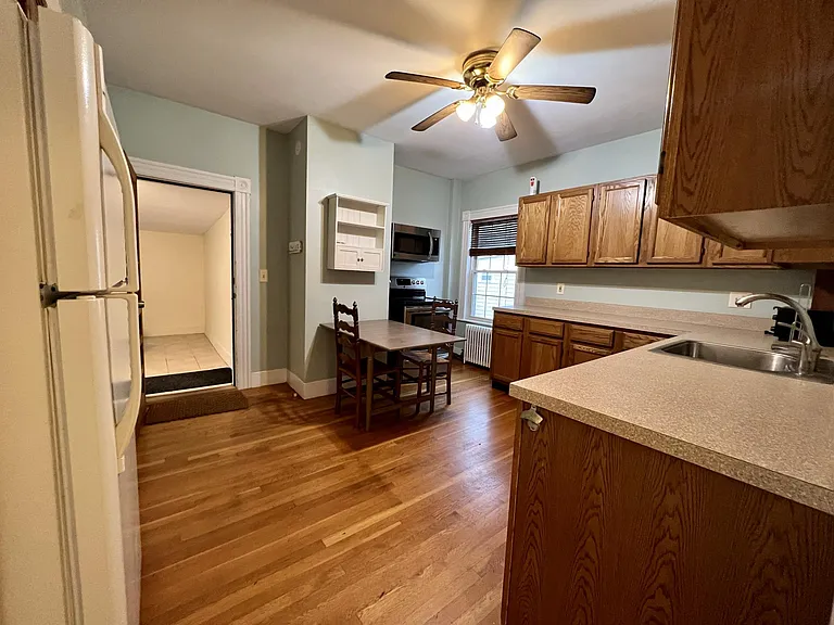 Eat-in kitchen with updated appliances, entrance to private mudroom
