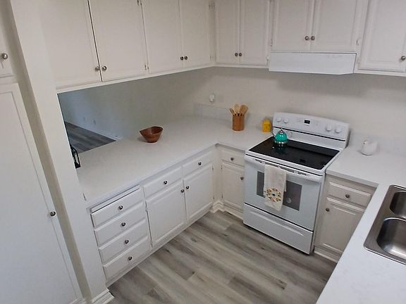 To the right will be the enrty to the large kitchen with loads of cabinets, pantry, stove and dishwasher all new appliances. White quartz countertops.