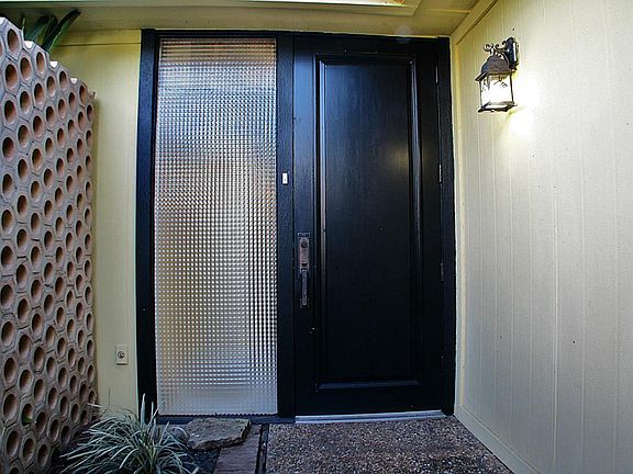 The front door has an attractive side light.