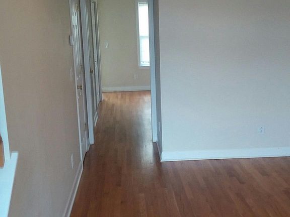 Hallway leads to kitchen and dining area
