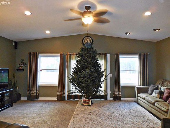 Spacious living room, vaulted ceilings, recess lighting & a walkout to patio