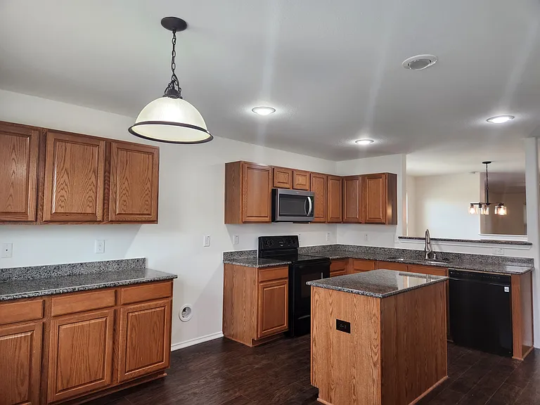 Large kitchen with island has room for breakfast table and huge walk-in pantry