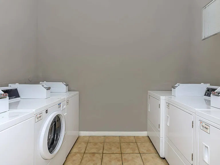 Modern laundry facility at North Forest Trails in Houston, TX with washers and dryers.