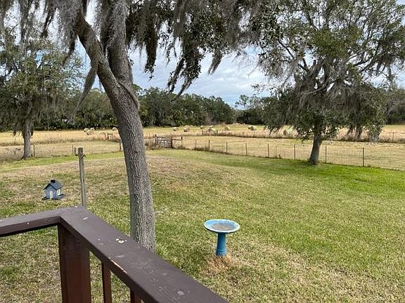 Back of residence overlooking hay field.