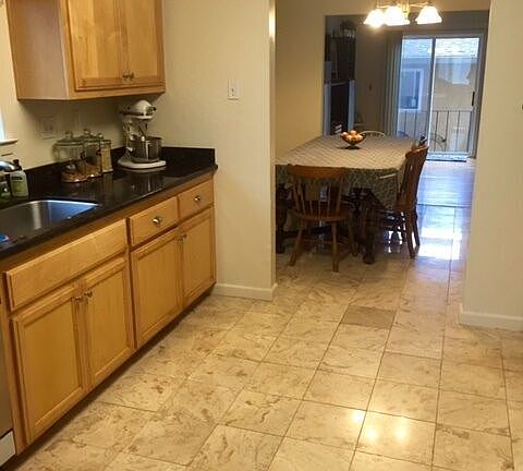 Granite Kitchen with Sliding door leading to patio