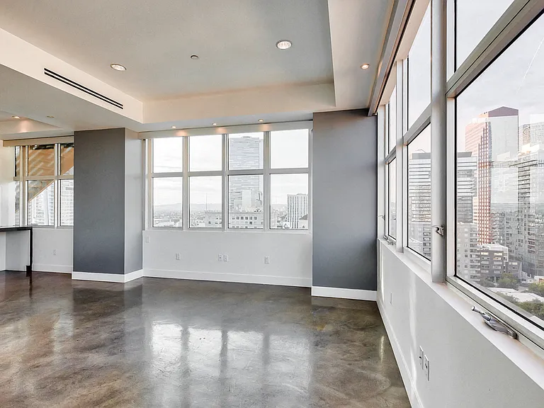 Walls of windows and stained concrete floors create an incredible entertaining space