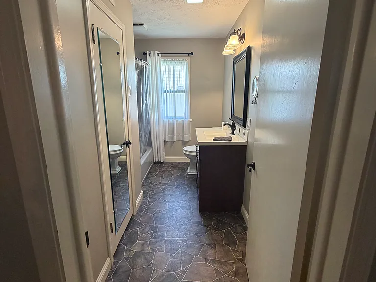 Full bathroom and large storage closet. Access to crawl space.