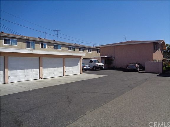 Rear View of Fourplex, Enclosed Garages and Parking S[aces
