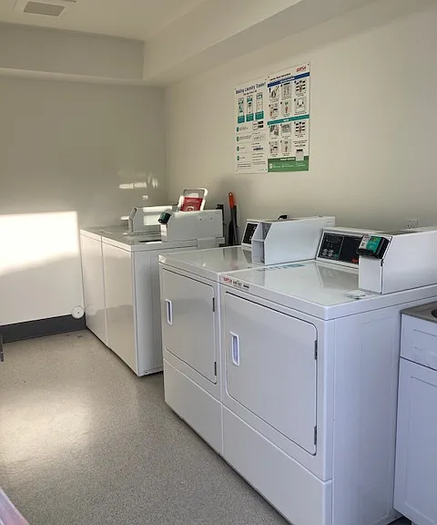 Community laundry room provides convenience for all washing/drying needs.