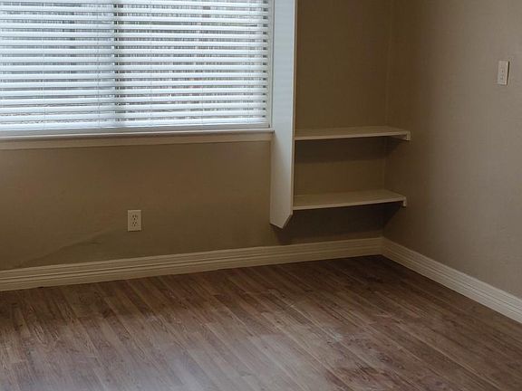 Master bedroom has new floors, builtin shelving, ceiling fan and a fresh coat of paint!