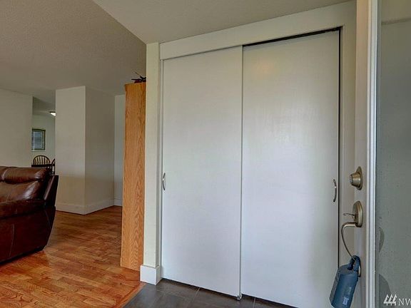 Front door with inlaid glass opens to tile entry