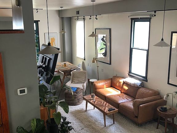 View of Living-Dinning area from Stairs. Plenty of Daylight East Facing Windows with roll-up shades.