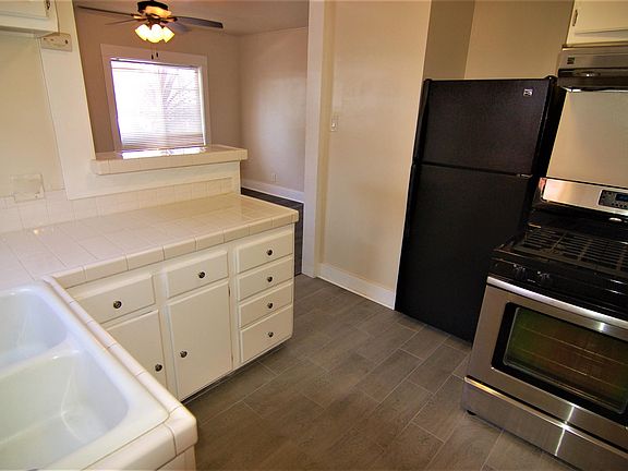 Kitchen has new tile flooring, newer stainless range and range hood, refrigerator/freezer