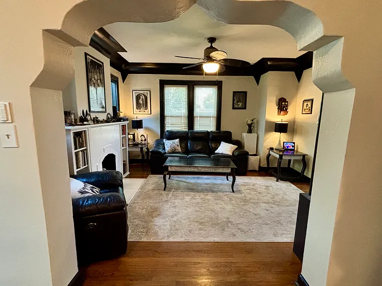 Shared living room with seating, fireplace, TV
