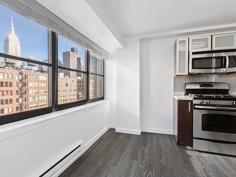 Large window view of city from kitchen