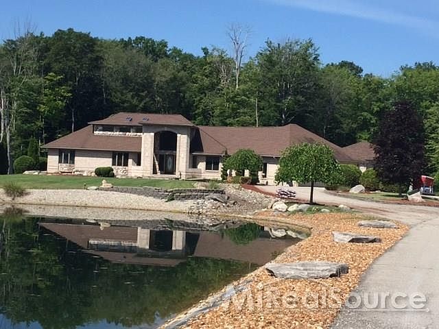 Beautiful Home, professional landscaping, lazy river flows from front of home to 1/4 acre stocked pond.