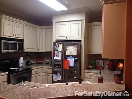 Kitchen view from dining room : Granite counter tops, custom finished cabinets, stainless steel appl