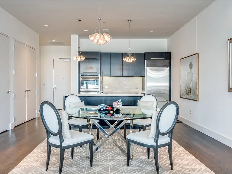 Dining space featuring dark wood-type flooring, recessed lighting, and a chandelier