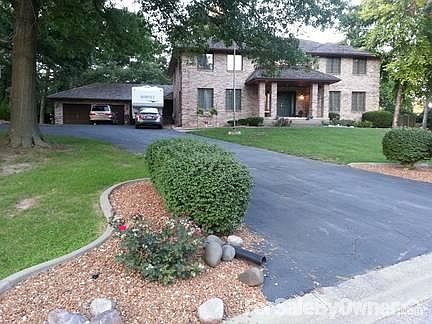 Front view from road.
						:
						Beautiful landscaped front yard with asphalt and concrete driveway.