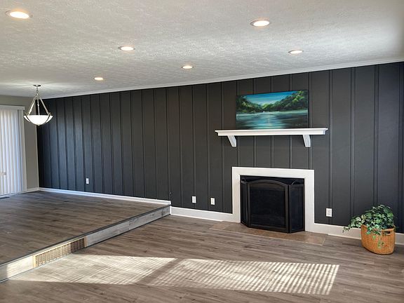 The great room includes new luxury vinyl flooring, fresh paint, recessed lighting.