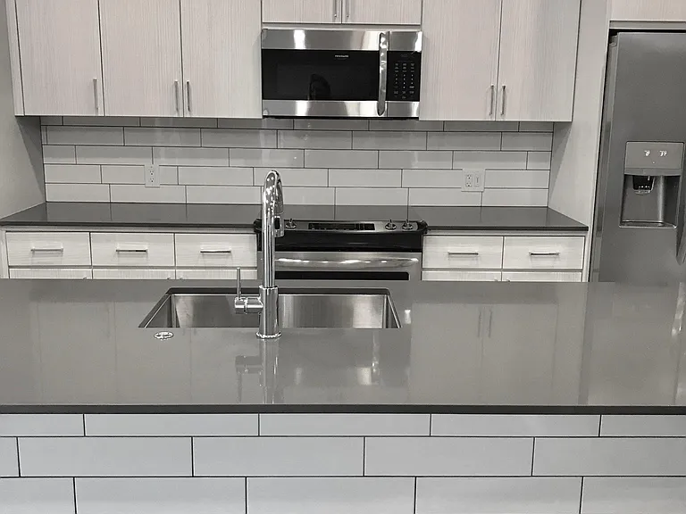Bright and modern kitchen with stainless steel appliances.