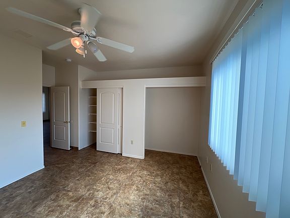 Primary bedroom with ceiling fan.