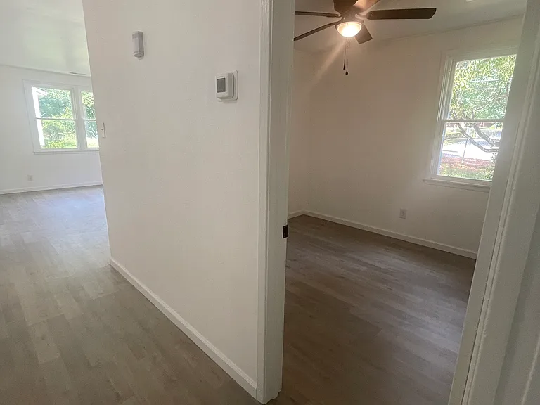 hallway view of living room and bedroom 3/office