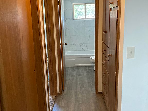 Hallway to bathroom with lots of storage