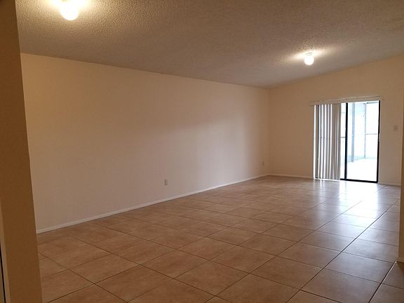Living area with sliding door to lanai/ pool