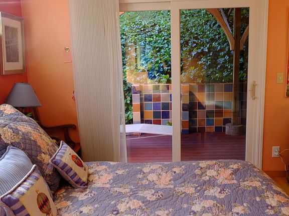 Downstairs bedroom with king size bed. Sliding glass doors lead you to your own patio with table and chairs for coffee or drinks separate from the rest of the group. No bedrooms share a common wall with another.