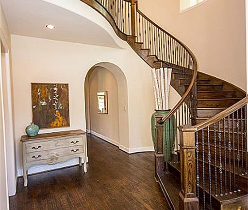 Architectural features lead the eye both down a deep hallway area and also sweeping staircase views in foyer.