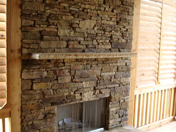 Outdoor Fireplace On Relaxing Screened Porch